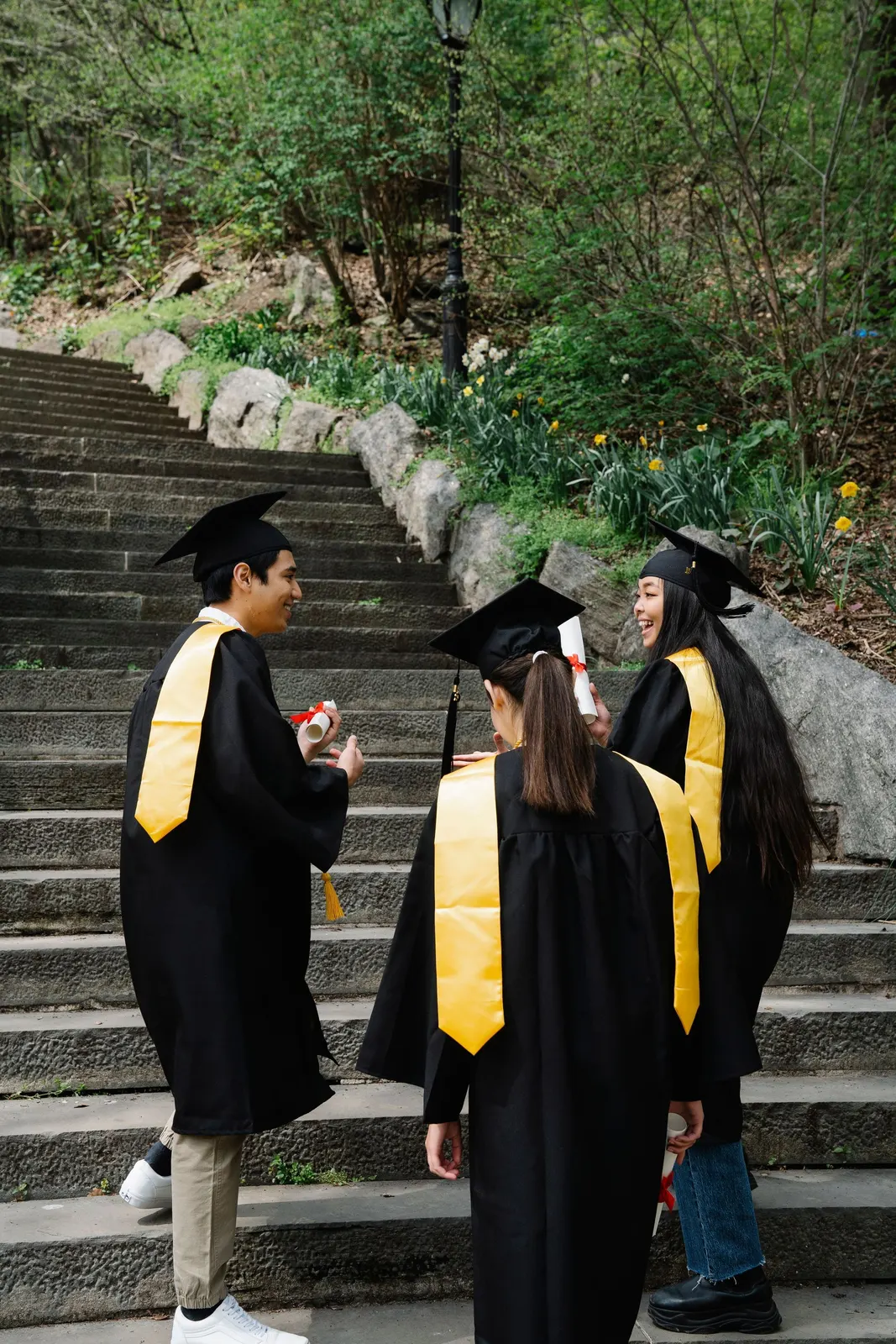 Graduates celebrating on outdoor steps (sample image)